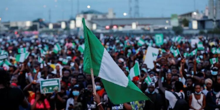 A crowd waving Nigerian National Flag
