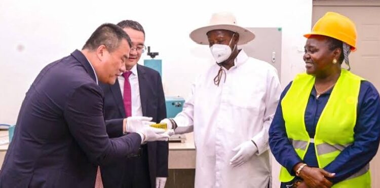 President Museveni receives a sample of refined gold from Wagagai Gold Mining project Wagagai MD Tan Jiuchang (L) during the commissioning of the facility in Busia on Saturday.