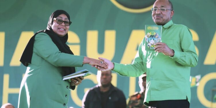 Tanzania's President Samia Suluhu Hassan, the presidential candidate of the ruling Chama Cha Mapinduzi (CCM) party, shakes hands with the President of Zanzibar, Dr. Hussein Ali Mwinyi, during the launch of the party's campaign for the upcoming general elections, at Tanganyika Packers grounds in Dar es Salaam, Tanzania, Thursday, Aug. 28, 2025.