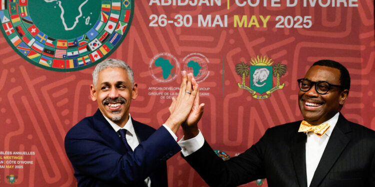 African Development Bank's (AfDB) newly elected president, Sidi Ould Tah gives a high five to outgoing president, Akinwumi Ayodeji Adesina, after the closing ceremony of the AfDB annual meeting, in Abidjan, Ivory Coast, May 30, 2025. REUTERS/Luc Gnago