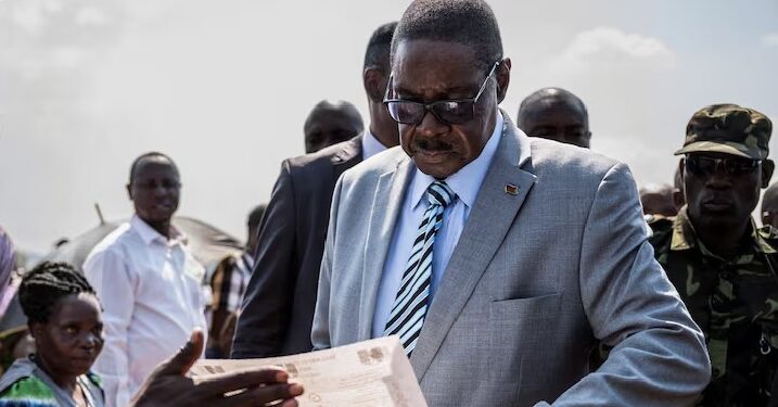 Malawi's presidential candidate and leader of the Democratic Progressive Party Peter Mutharika inspects a ballot paper before casting his vote during the general election at Thyolo District, south of Blantyre, Malawi, September 16, 2025.