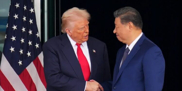 US President Donald Trump and Chinese President Xi Jinping shake hands as they depart following a bilateral meeting at Gimhae Air Base in Busan, South Korea, on October 30, 2025