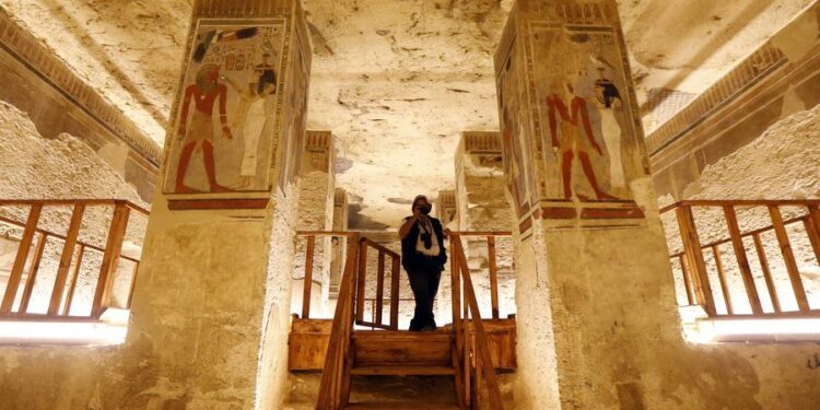 A tourist takes photos while visiting the tomb of New Kingdom Pharaoh Amenhotep III in the Valley of the Kings on the West Bank of Luxor, Egypt, on Oct. 4, 2025.