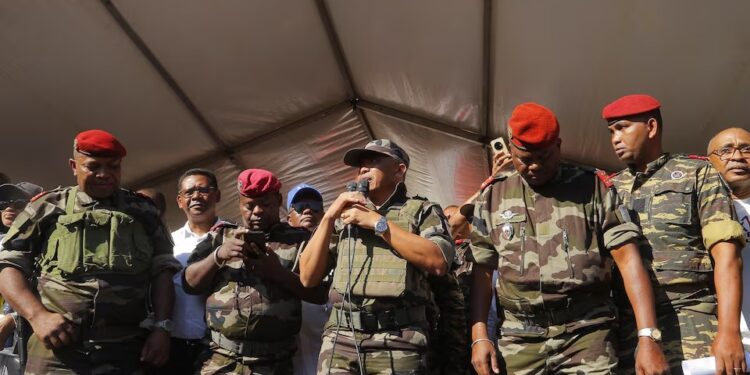 Colonel Michael Randrianirina addresses protesters gathered outside the town hall on Independence Avenue during a nationwide youth-led demonstration against frequent power outages and water shortages, in Antananarivo, Madagascar, October 14, 2025
