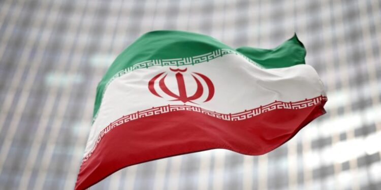 FILE PHOTO: Iranian flag flies in front of the UN office building, housing IAEA headquarters, amid the coronavirus disease (COVID-19) pandemic, in Vienna, Austria, May 24, 2021. REUTERS/Lisi Niesner/File Photo