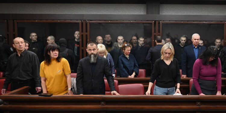 Lawyers of Ukrainian soldiers of the Aidar battalion captured by Russia during fighting in Ukraine stand in front of the defendants' cage during a hearing at the Southern District Military Court in Rostov-on-Don, Russia, Friday, Oct. 17, 2025.
