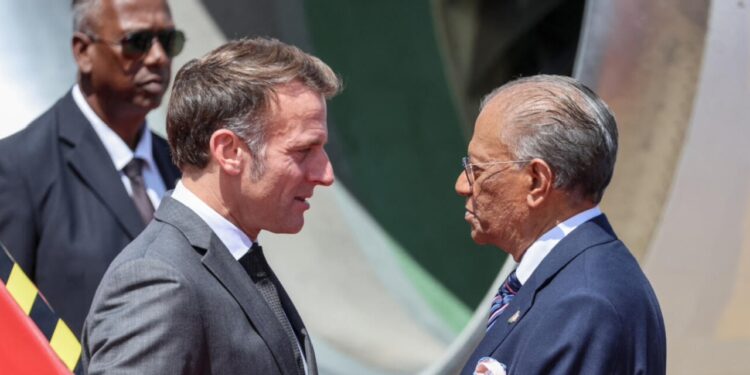 France's President Emmanuel Macron is received by Mauritian Prime Minister Navin Ramgoolam upon his arrival for his visit to Mauritius, at the Sir Seewoosagur Ramgoolam International Airport in Port Louis on 20 November 2025.