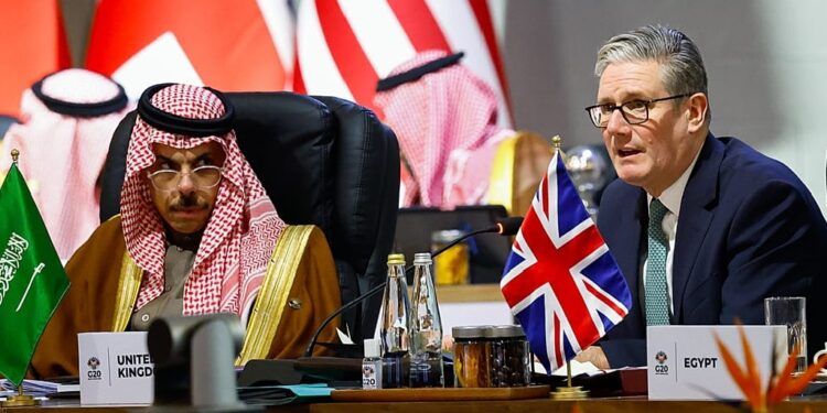 British Prime Minister Keir Starmer, right, attends a plenary session on the opening day of the G20 Summit, in Johannesburg, South Africa, 22 November 2025