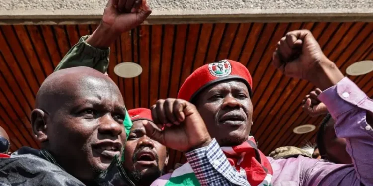 Nicholas Oyoo (L) and Bob Njagi (R) greeted by supporters when they arrived back in Kenya's capital, Nairobi, on Saturday