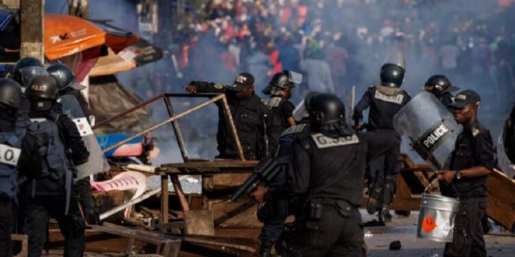 Members of the security forces remove barricades during a protest by supporters of Cameroon presidential candidate Issa Tchiroma