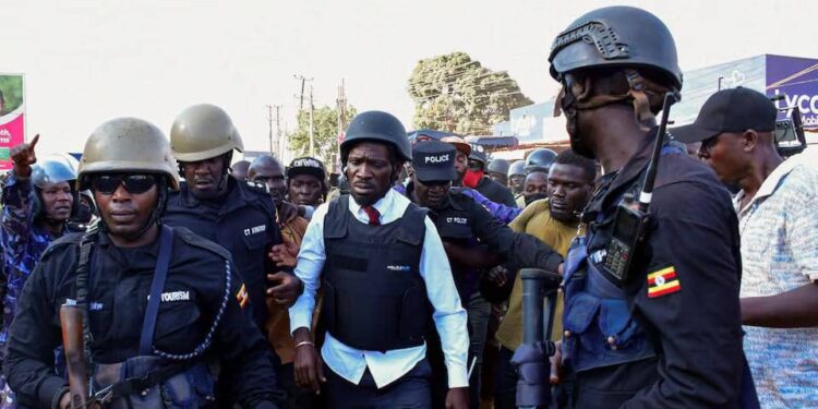 Ugandan Presidential candidate Robert Kyagulanyi, also known as Bobi Wine, of the National Unity Platform (NUP) party, is escorted by law enforcement officers during a campaign rally ahead of the general elections in Kampala, Uganda December 8, 2025.