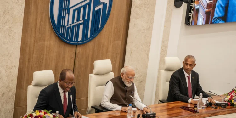 Indian Prime Minister Narendra Modi, centre sits between Ethiopia's House of People's Representatives Speaker Tagesse Chafo, left, and House of Federation Speaker Agegnehu Teshager during a visit at the parliament in Addis Ababa, Ethiopia, Wednesday, Dec. 17,