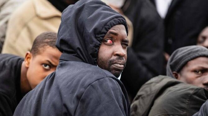A migrant onboard a rubber boat looks on as they wait to be rescued by crew members of the “Ocean Viking” rescue ship during a rescue operation in the search-and-rescue zone off the international waters of Libya