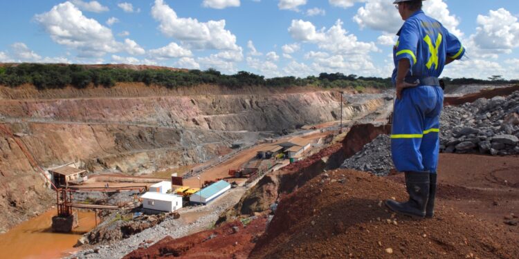 A mine supervisor overlooks Metorox's Chibuluma copper mine, near Kitwe, Zambia, on Thursday Feb. 7, 2008. The price of copper, Zambia's largest export, has surged more than threefold this decade. Photographer: Naashon Zalk/Bloomberg News