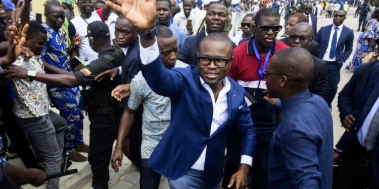 Romuald Wadagni, Benin’s finance minister and the ruling party candidate for the presidential election, waves after presenting his platform in Cotonou, Benin March 21, 2026