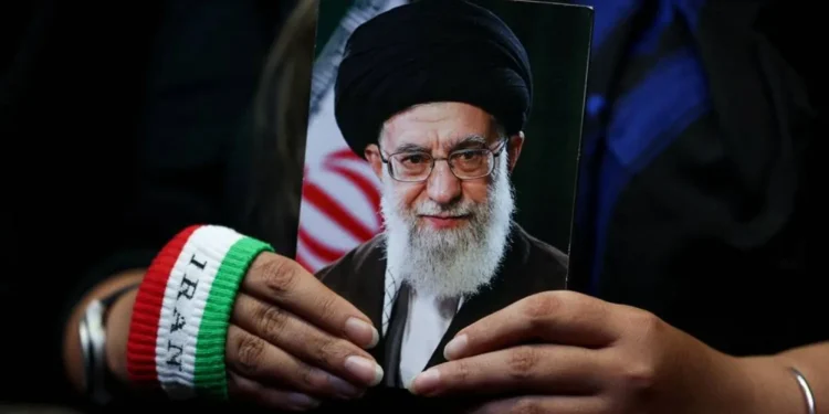 A woman holds an image of late Iranian Supreme Leader Ali Khamenei during a rally in Tehran, Iran, May 29, 2026