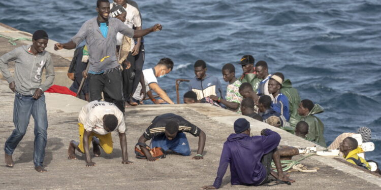 FILE - Migrants react as they arrive at the port in La Restinga on the Canary island of El Hierro, Spain, on, Aug. 19, 2024. (AP Photo/Maria Ximena, File)