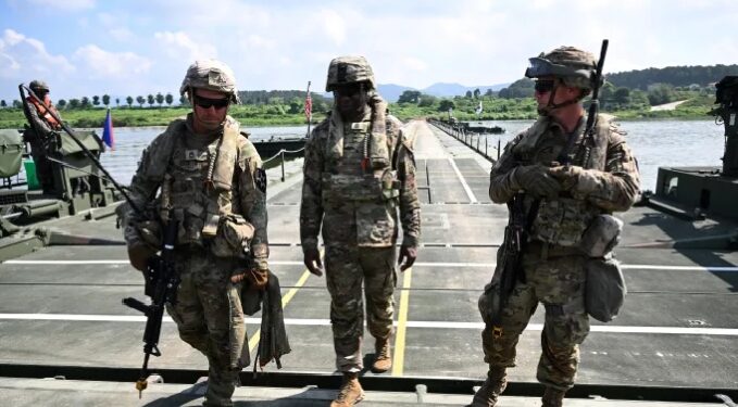 US soldiers walk on a floating bridge during a South Korea-US joint river-crossing drill as part of the annual Ulchi Freedom Shield military exercise in Yeoju on August 27, 2025