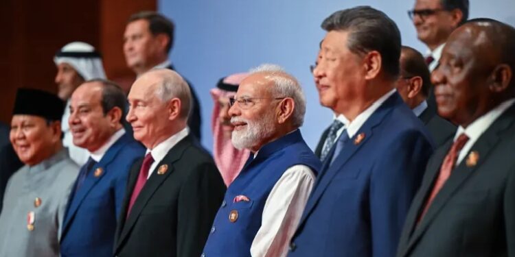 Russia's President Vladimir Putin (3L), India's Prime Minister Narendra Modi (3R) and China's President Xi Jinping (2R) posing with other leaders for a family photo during the 18th BRICS Summit in New Delhi on September 13, 2026