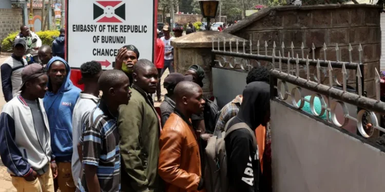 Burundi nationals waiting outside their country's embassy in Kenya to receive free travel documents to return home