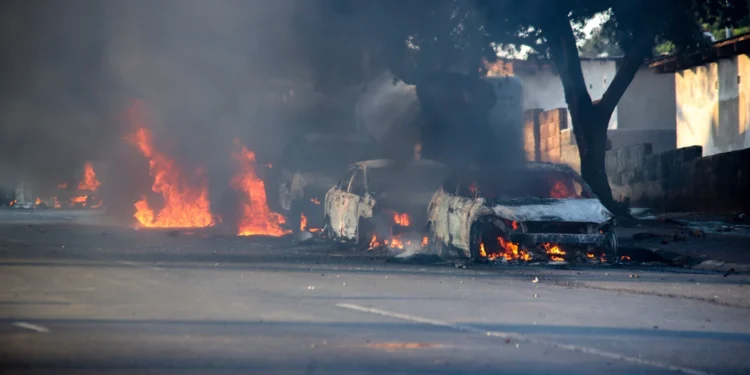 Cars burn after they were set alight during protests related to immigration issues in Soweto, Johannesburg, Thursday, Oct. 8, 2026.